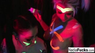 Black-light Babes Nadia White and Ophelia Suck off a Colorful Cock