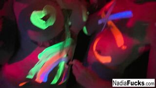 Black-light babes Nadia and Ophelia suck off a colorful cock